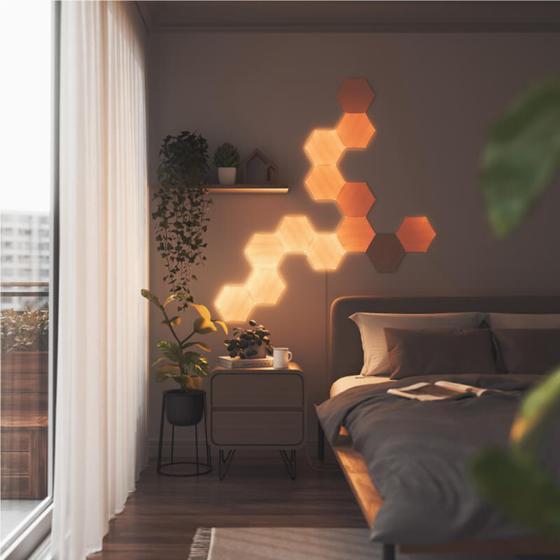 Nanoleaf Elements Thread-enabled wood-look hexagon smart modular light panels mounted to a wall in a bedroom. HomeKit, Google Assistant, Amazon Alexa, IFTTT.