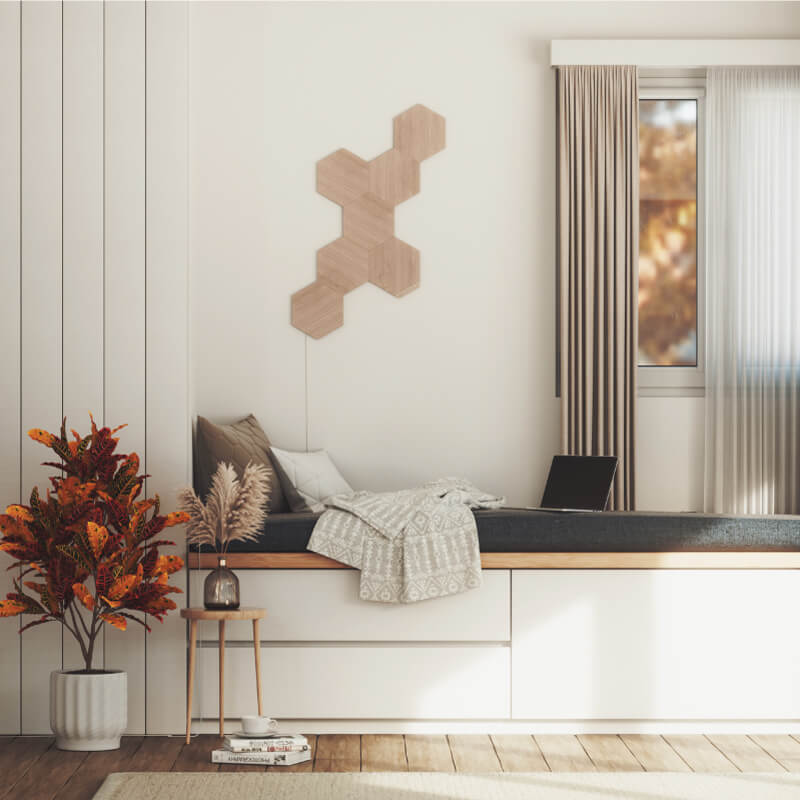 Nanoleaf Elements Thread-enabled wood-look hexagon smart modular light panels mounted to a wall above a cozy nook. HomeKit, Google Assistant, Amazon Alexa, IFTTT.